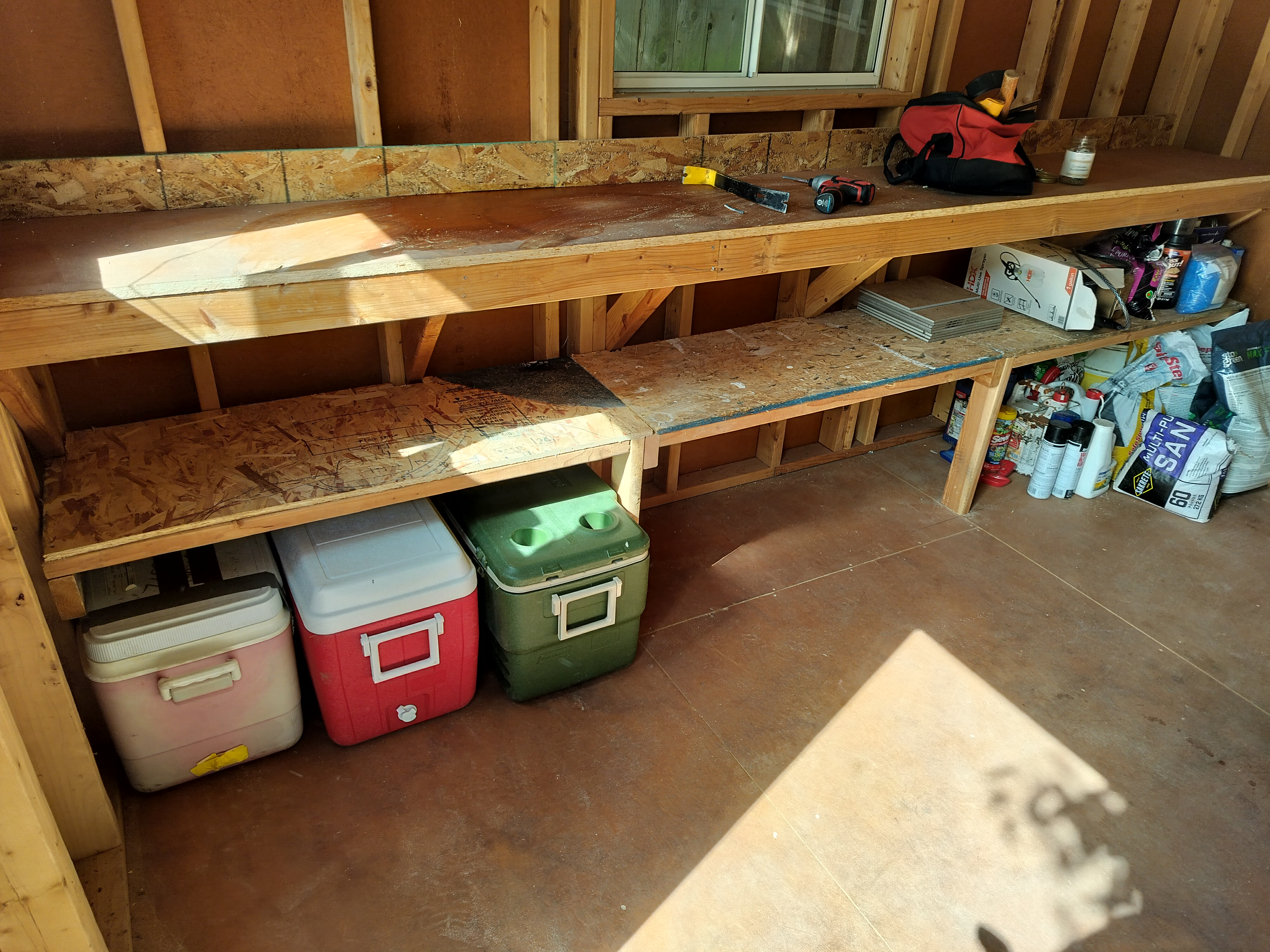 Completed organized shed shelving with tools and equipment properly stored